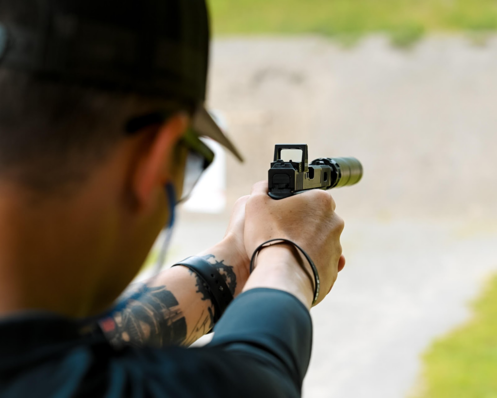 Man shooting a firearm at a shooting range