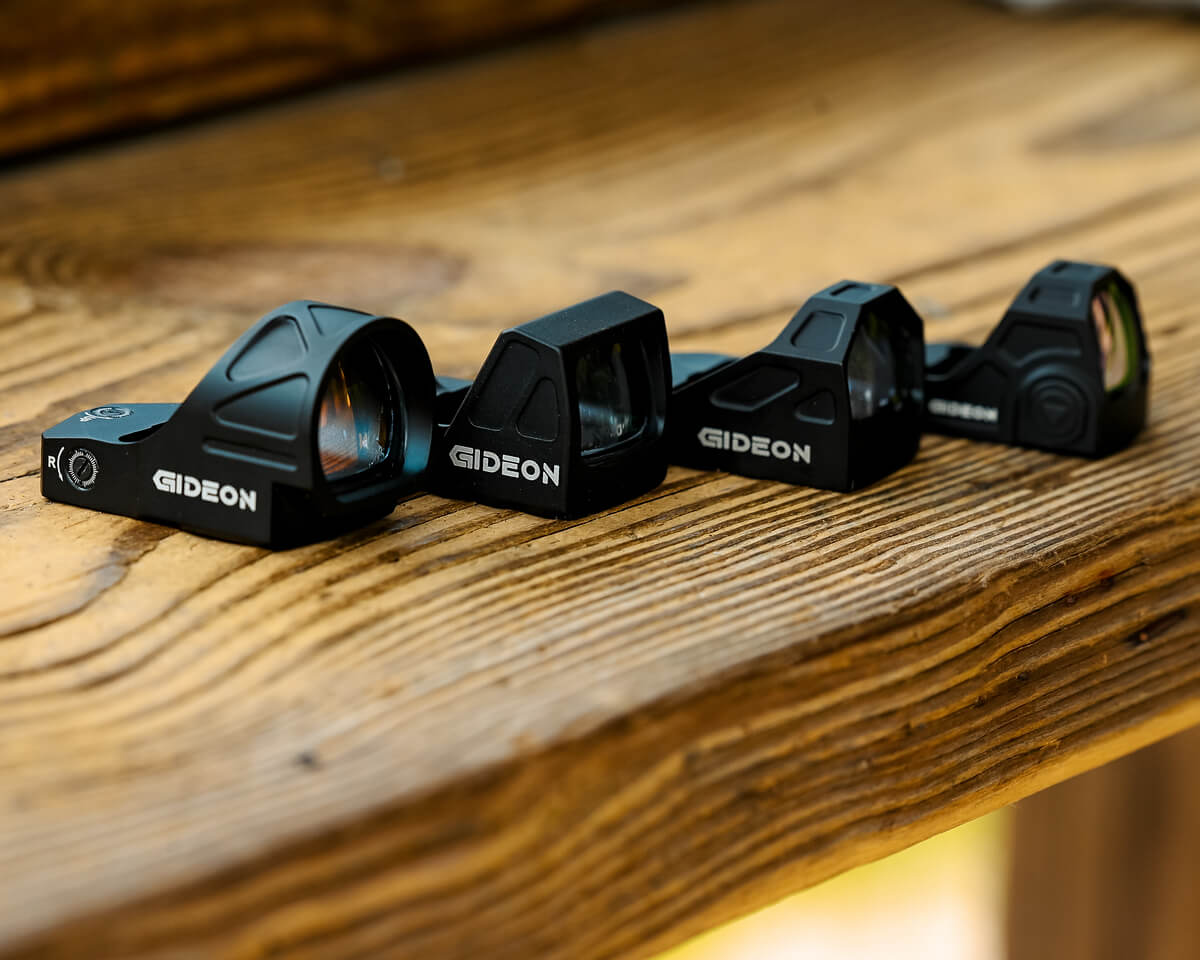 4 Gideon Optics sights sitting on a wooden table