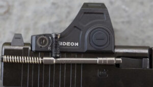 Slimline Glock with an optic mounted showing a screw jam