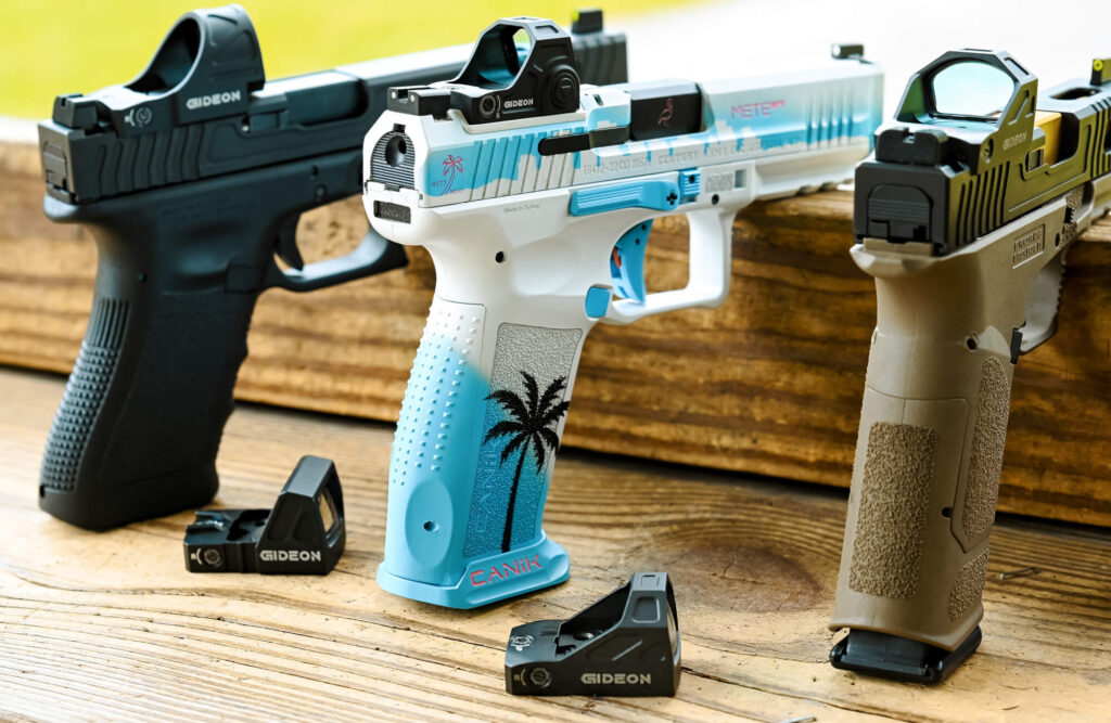 3 firearms with Gideon Optics red dot sights mounted are sitting on a wooden ledge