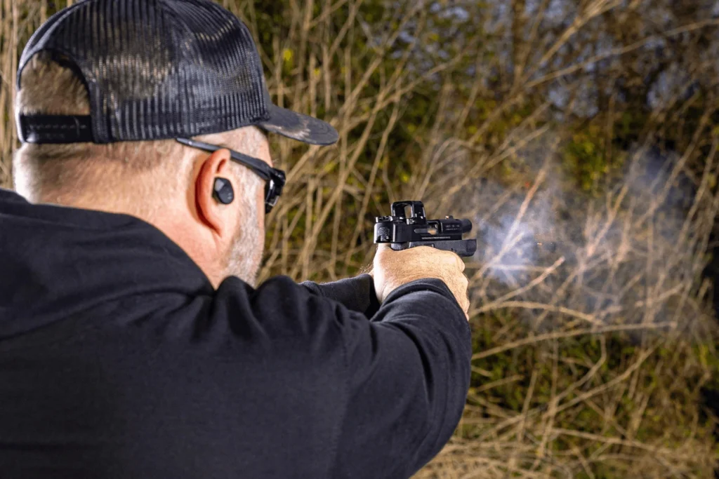 Behind the shoulder view of a man testing the Valor MIni Red Dot on his everyday carry pistol