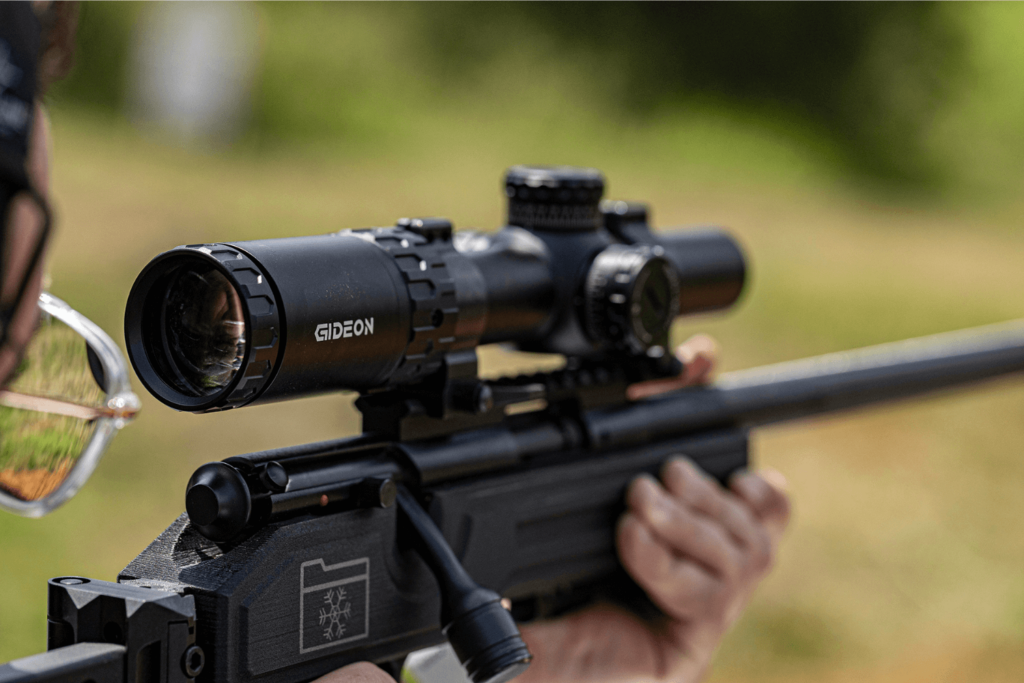 Close up of a Guardian LPVO mounted to a firearm at an outdoor shooting range