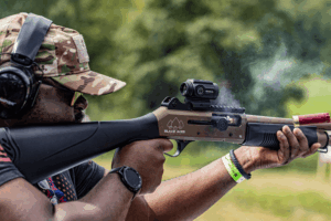 eye relief red dot - Gideon Optics Man firing a shotgun with a Gideon Optics Advocate mounted