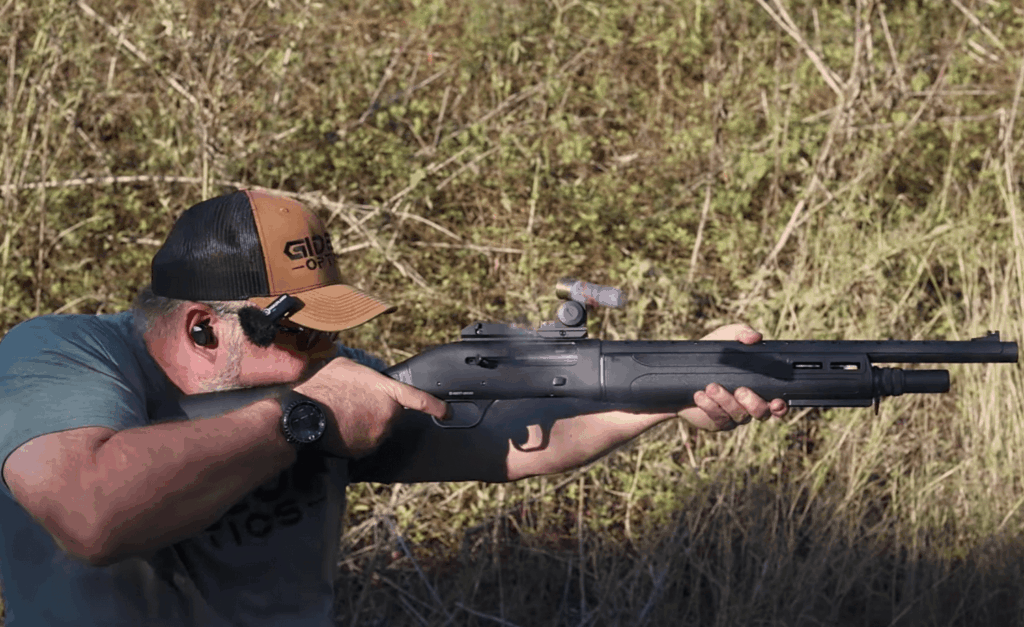Mike from Gideon Optics demonstrating firing a semi-automatic shotgun with a red dot mounted