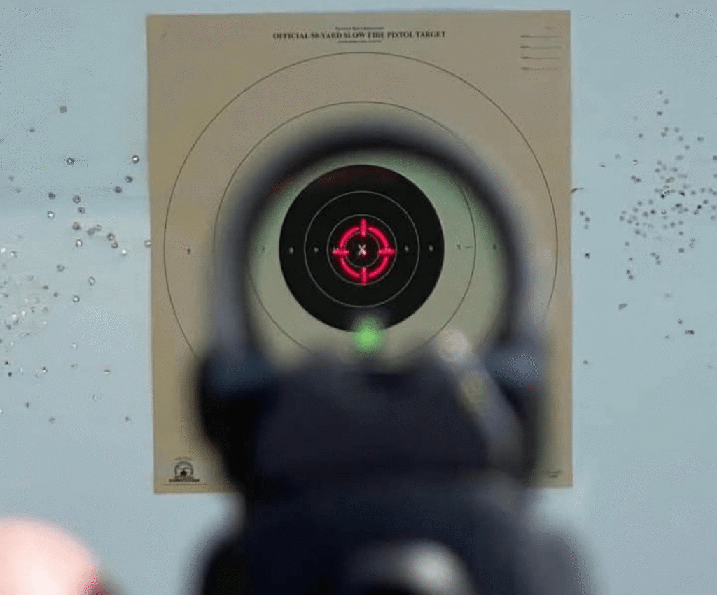 red circle dot reticle aimed at a shooting target