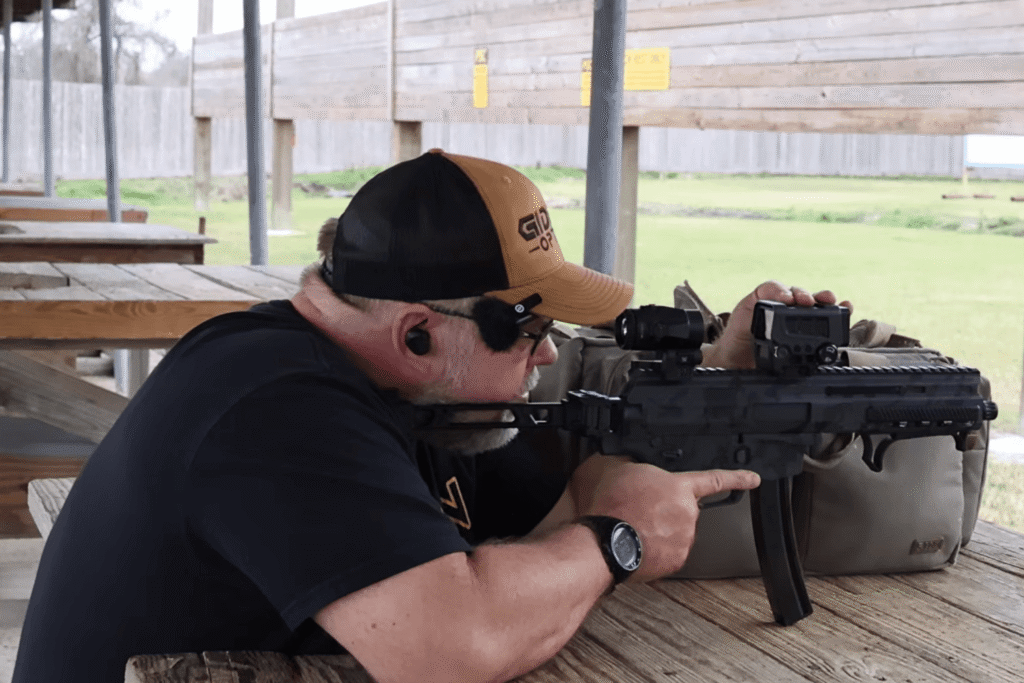 Mike from Gideon Optics zeroing a red dot mounted to a rifle at an outdoor shooting range