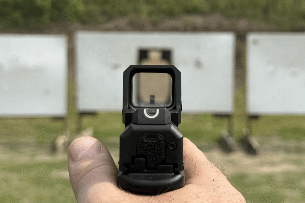 View through window of a dead red dot showing iron sights