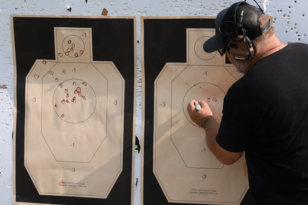 Mike from Gideon Optics showing the target results of using iron sights when red dot dies