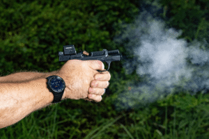 Man firing a Bodyguard 2.0 with a Pebble E mounted