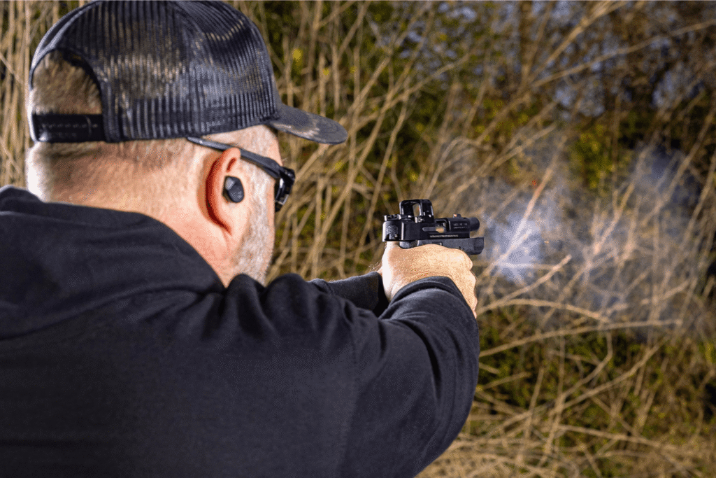 Man firing a bodyguard 2.0 with a Pebble E mounted