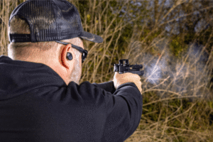 Man firing a bodyguard 2.0 with a Pebble E mounted