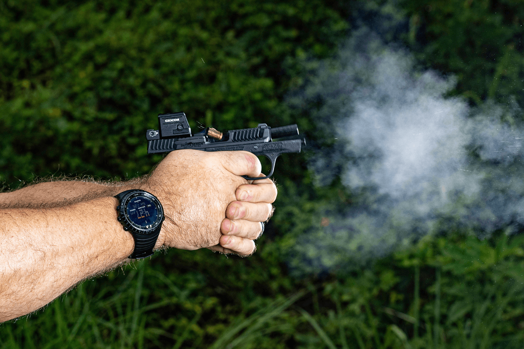 Man's arms aiming and firing a S&W Bodyguard 2.0 with a Gideon Optics Pebble mounted